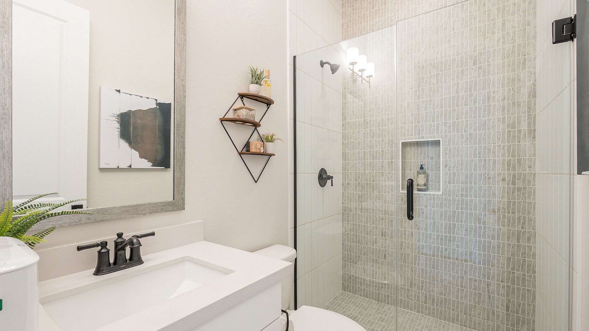 Luxurious glass shower with textured tile and sleek fixtures at Hacienda at Estrella.