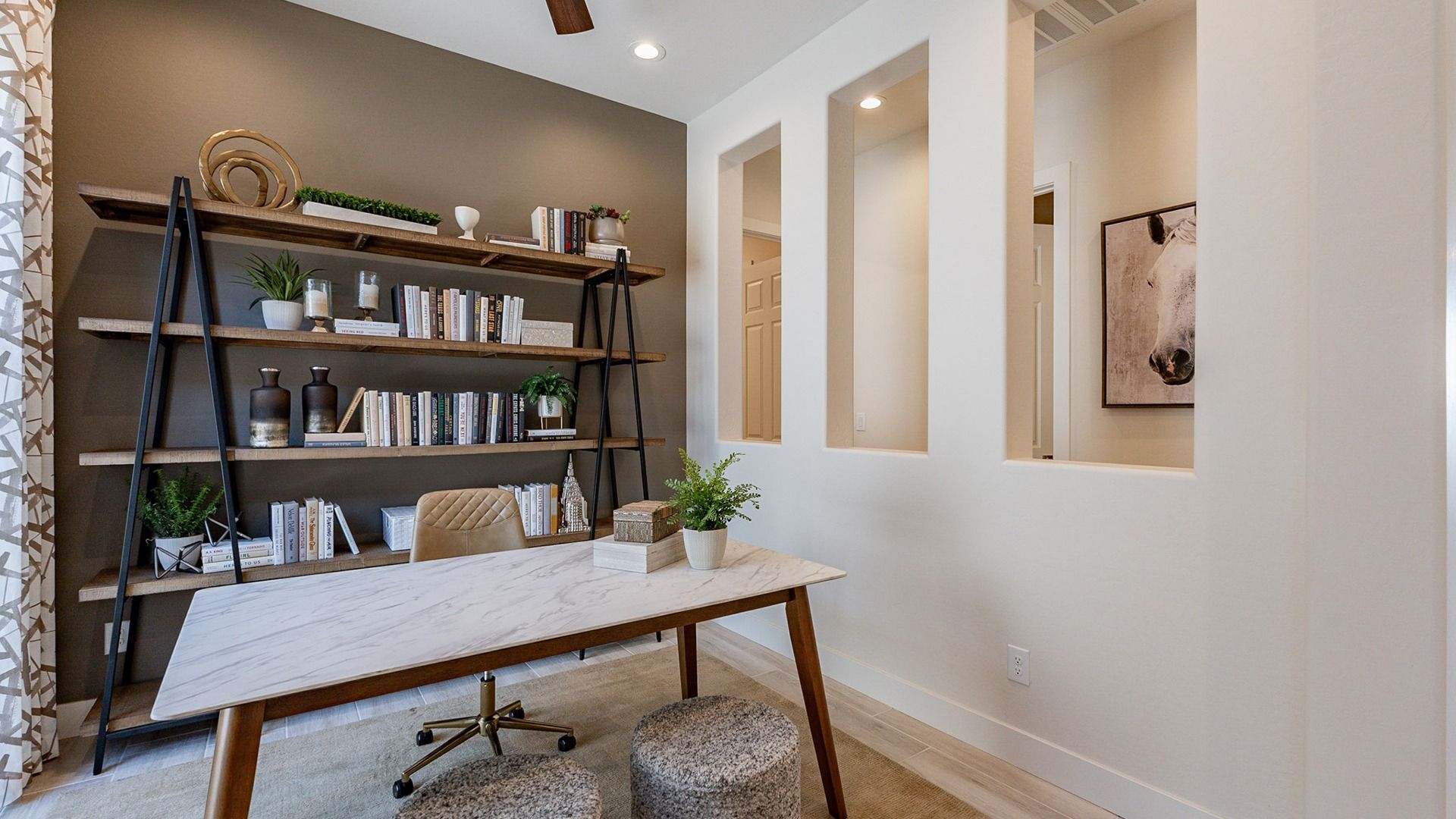 Featuring a sleek marble desk and striking open shelving, this Windrose office embodies modern luxury.