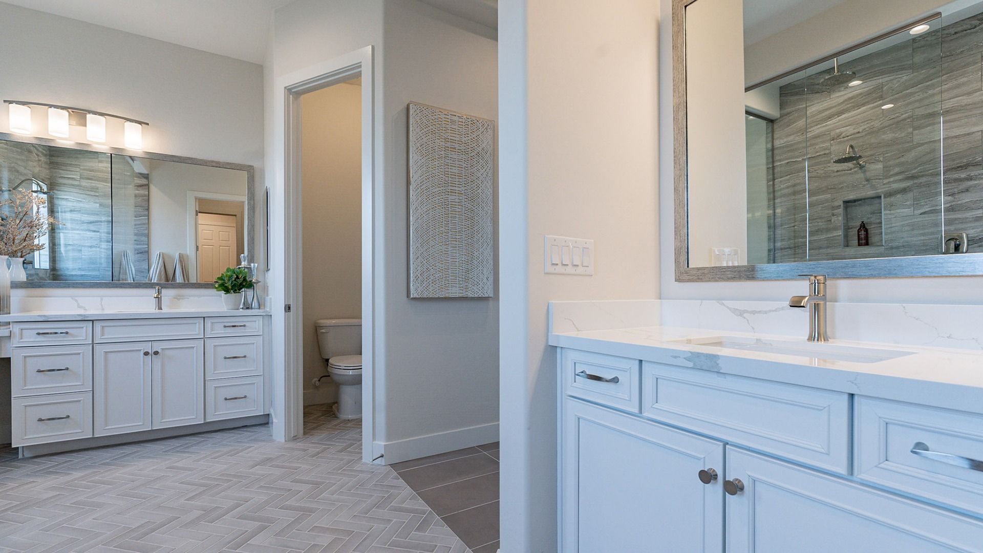 Exquisite dual vanities, marble countertops, and elegant lighting in Windrose community offer refined luxury.