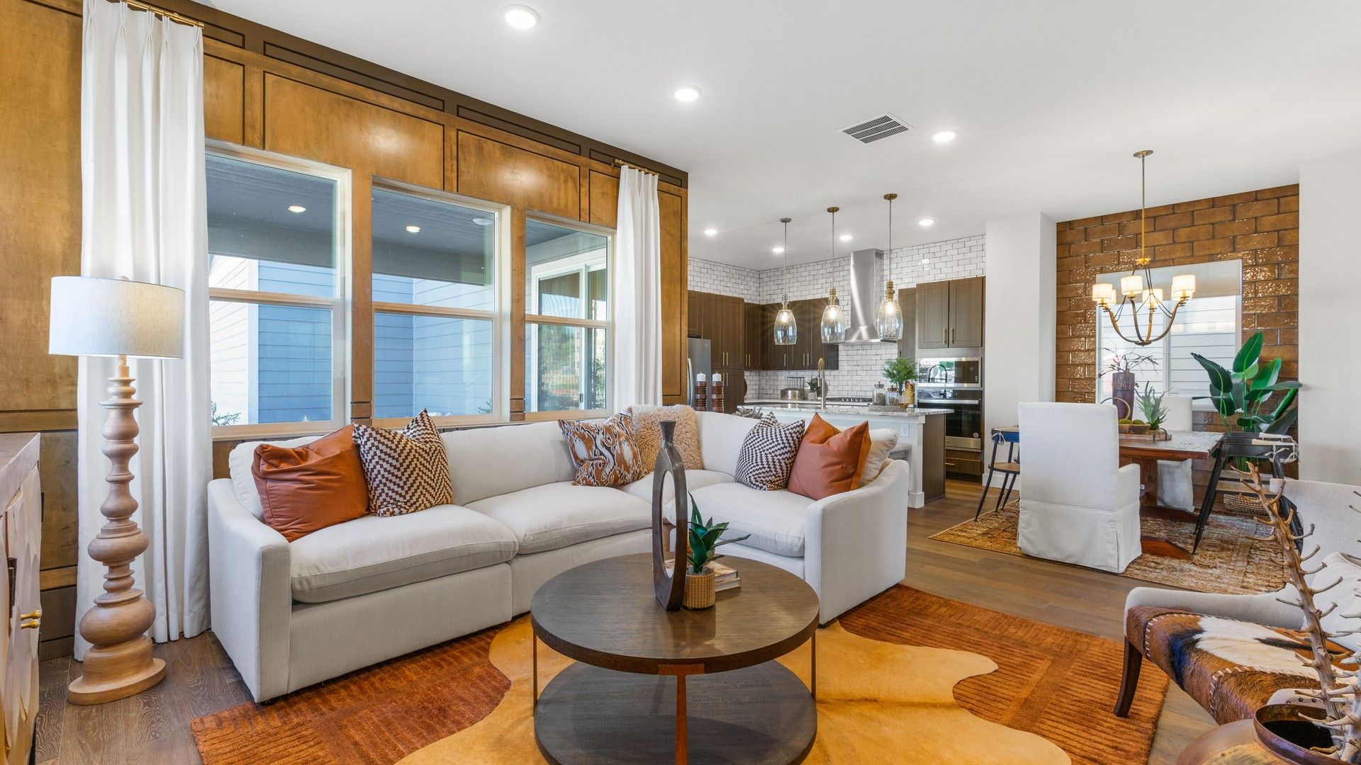 Experience refined elegance with rich wood features and contemporary lighting in Dillon Pointe's exquisite living area.