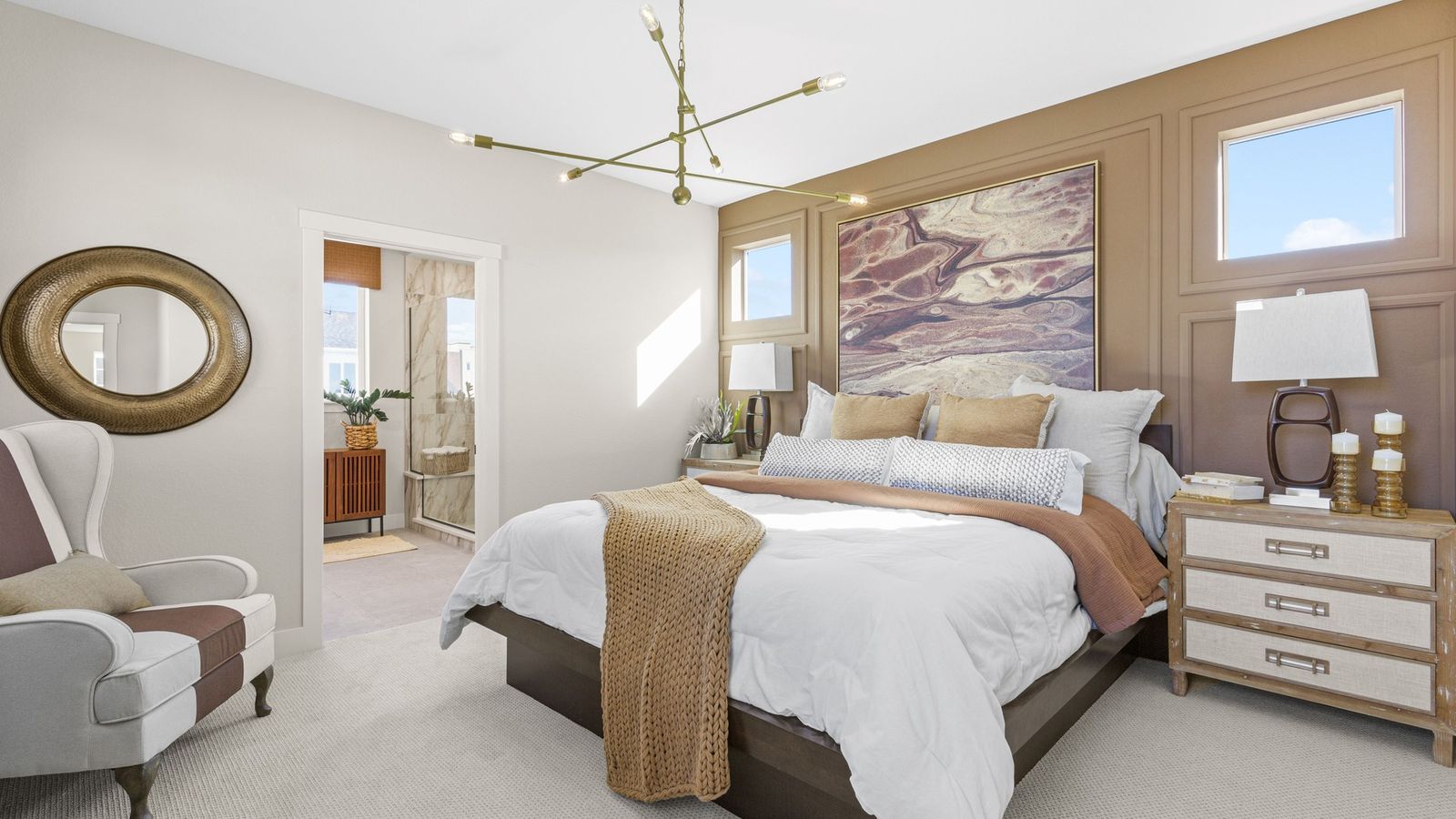 Modern chandelier, plush textures, and striking artwork enhance this Dillon Pointe bedroom's refined elegance.