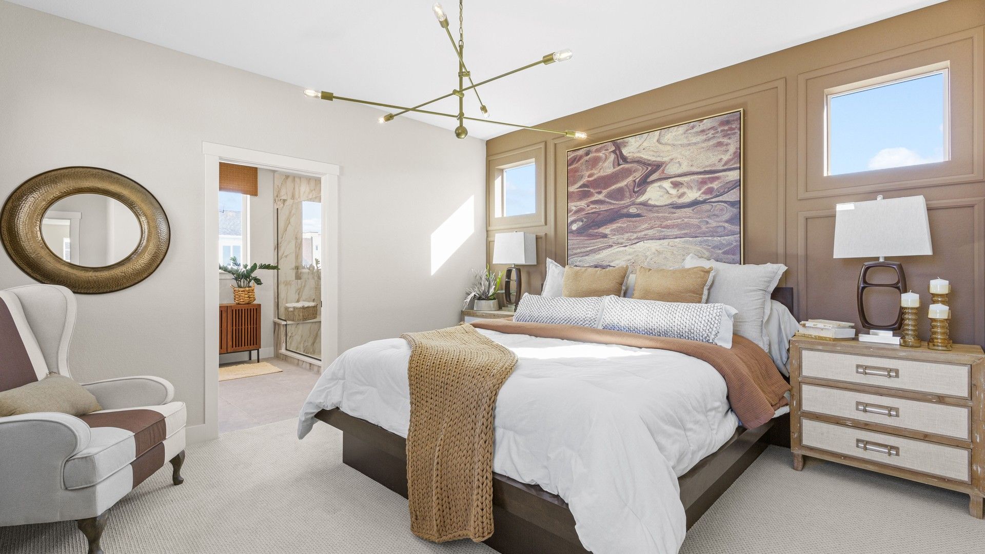 Modern chandelier, plush textures, and striking artwork enhance this Dillon Pointe bedroom's refined elegance.