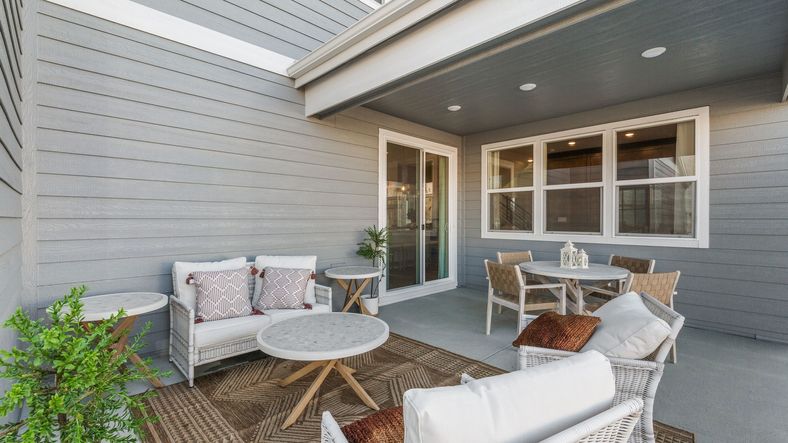 Elegant Dillon Pointe patio with sleek wooden paneling and luxurious wicker seating. Ideal for refined outdoor living.
