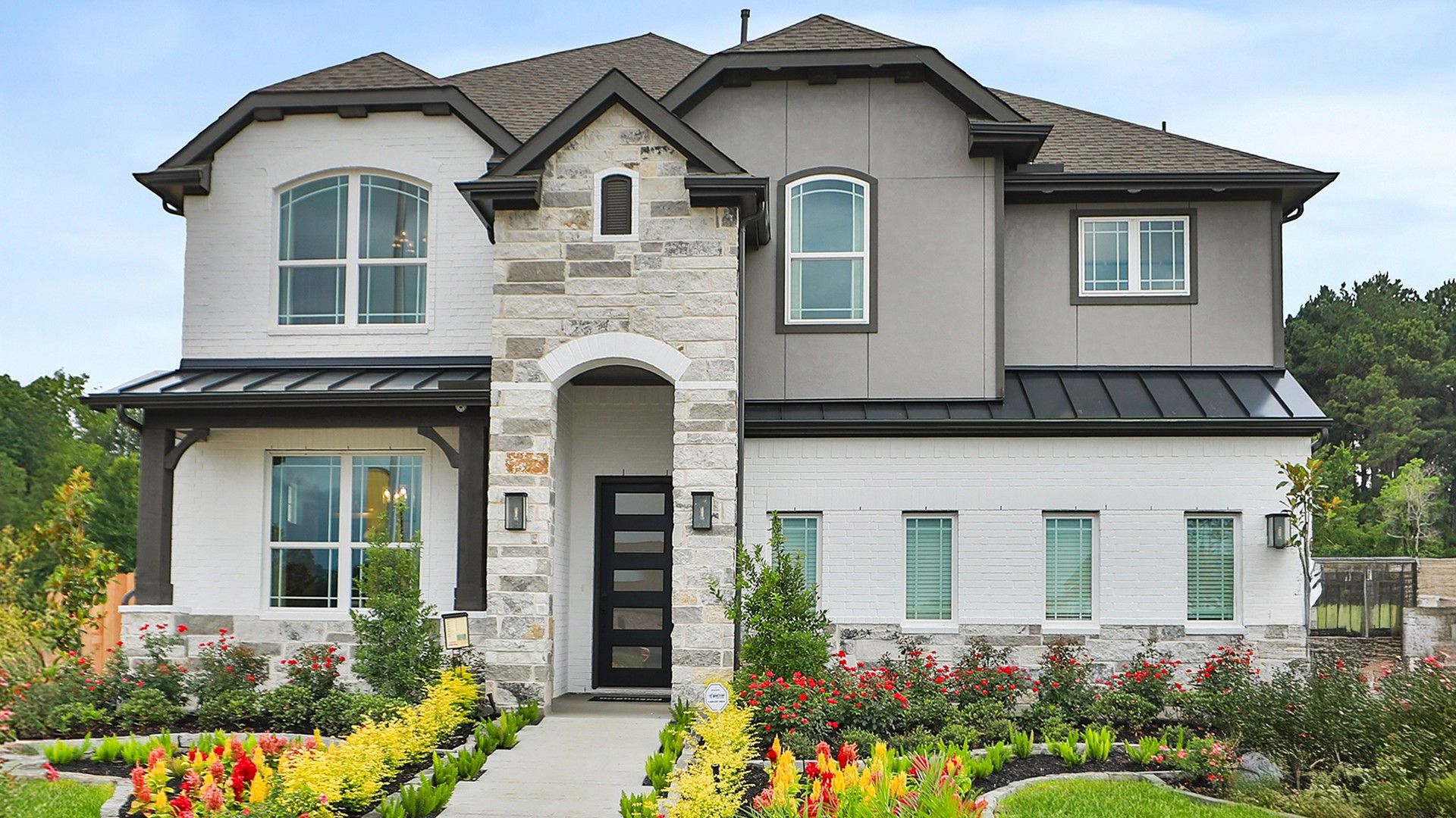 Exquisite stone and brick facade blend effortlessly in this Katy Lakes gem, surrounded by vibrant landscaping.