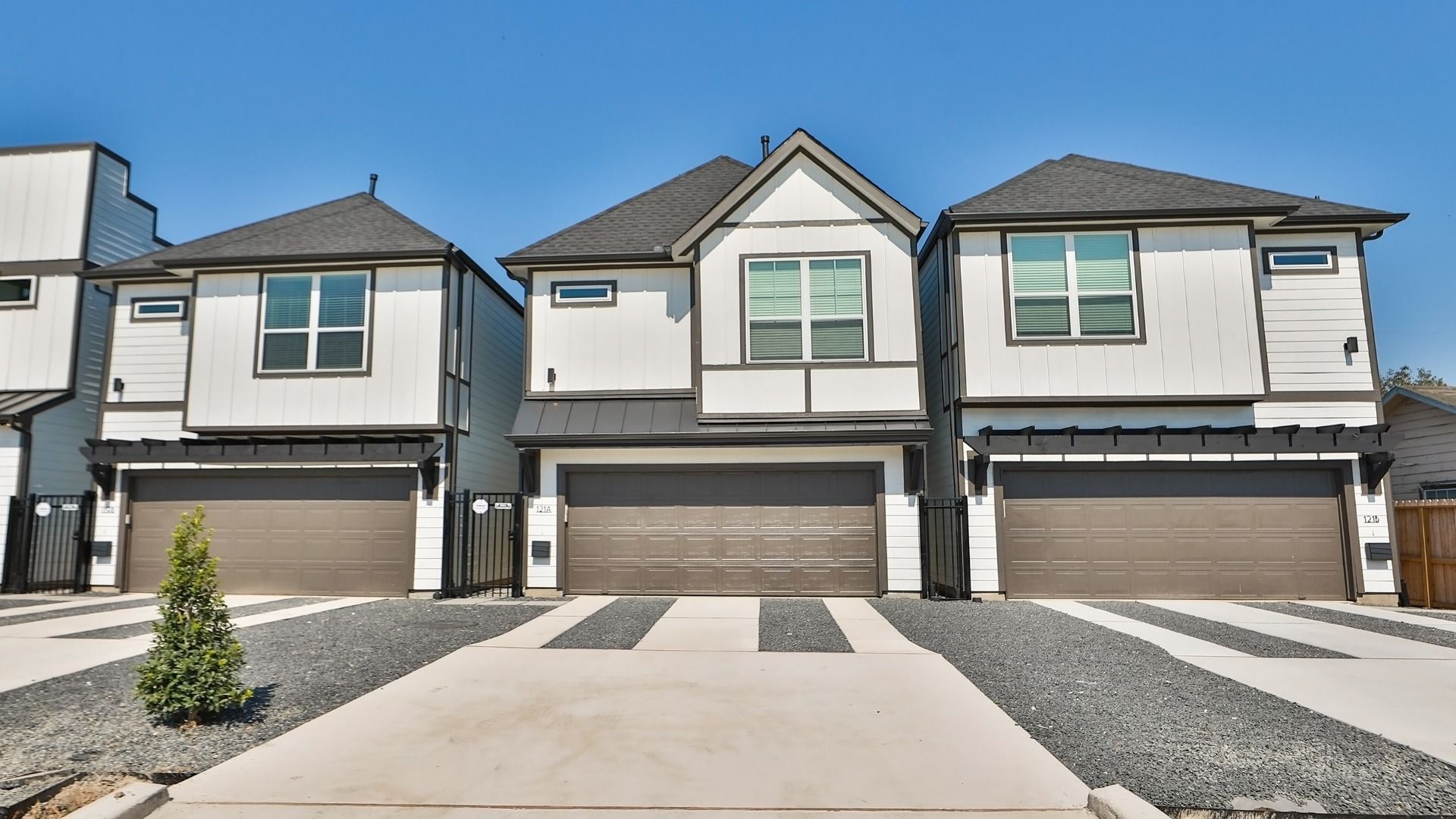 Luxurious townhome with elegant gabled roof, refined siding, and meticulous landscaping in Houston’s Independence Height