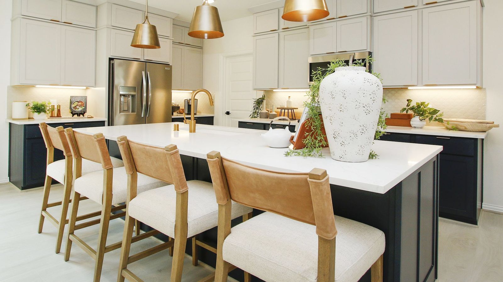Luxurious Bridgeland Central kitchen with chic pendant lighting, quartz countertop, and leather seating.