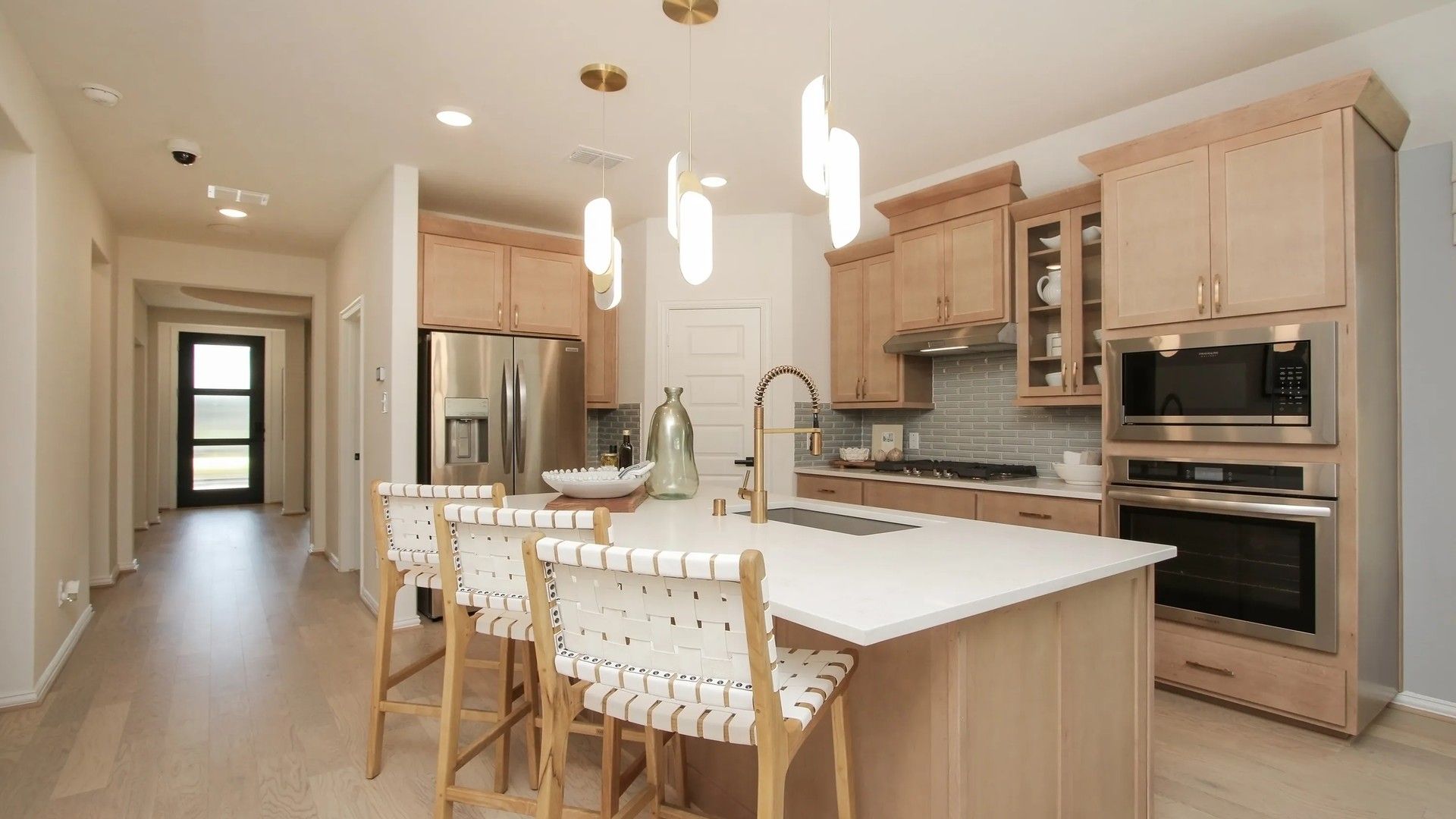 Luxurious Ellis Cove kitchen features sleek wood cabinetry and elegant marble countertops.