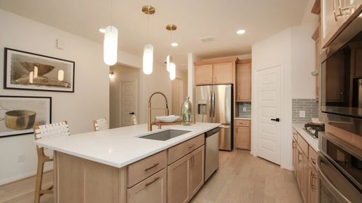 Luxurious kitchen with quartz countertops, custom cabinetry, stainless steel appliances in Ellis Cove.