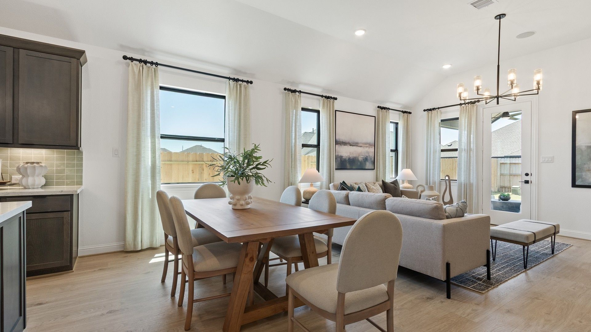 Experience elegance with soaring ceilings and sleek lighting in Oakwood Estates' living area.