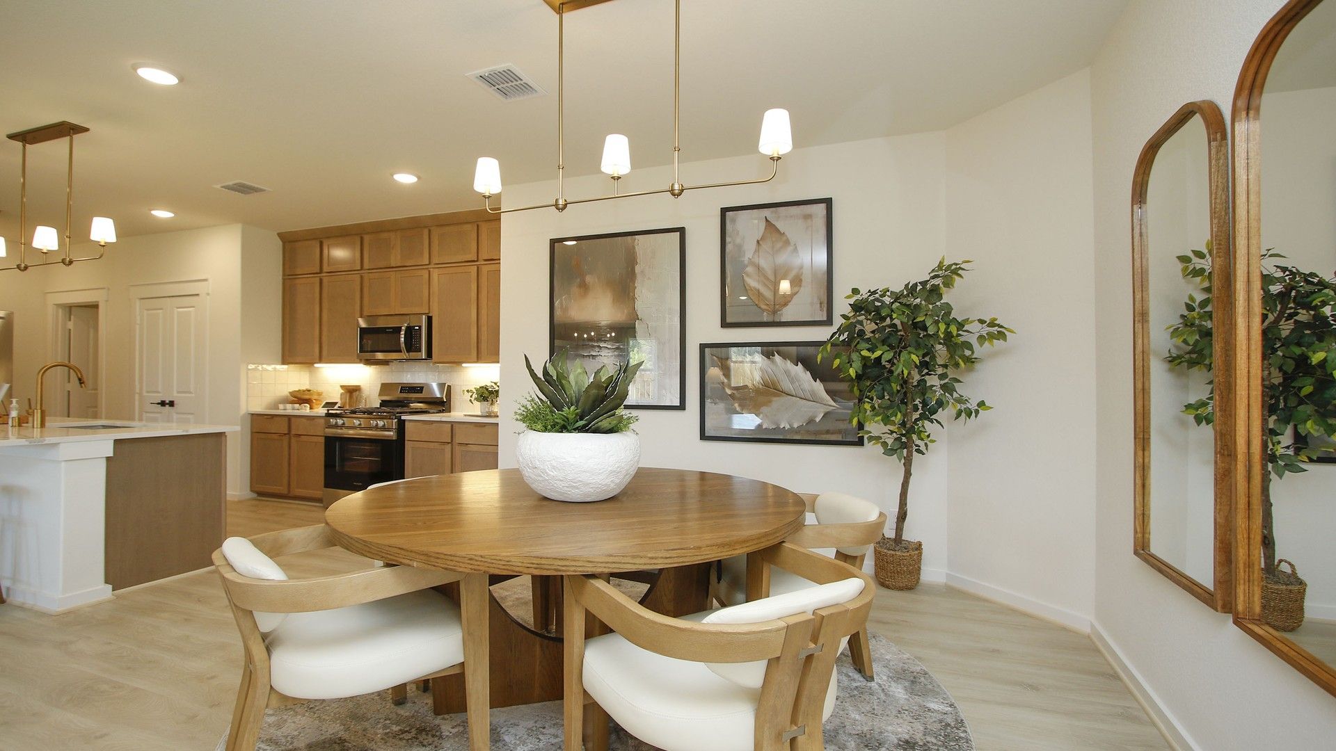 Luxurious wood accents and chic pendant lighting define this elegant dining space in Cielo community.