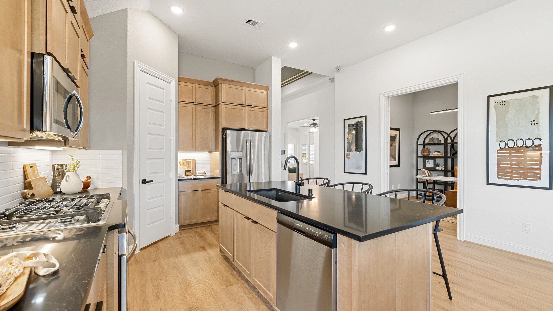 Elegant Southern Pointe kitchen with sleek black countertops and premium wood cabinetry.