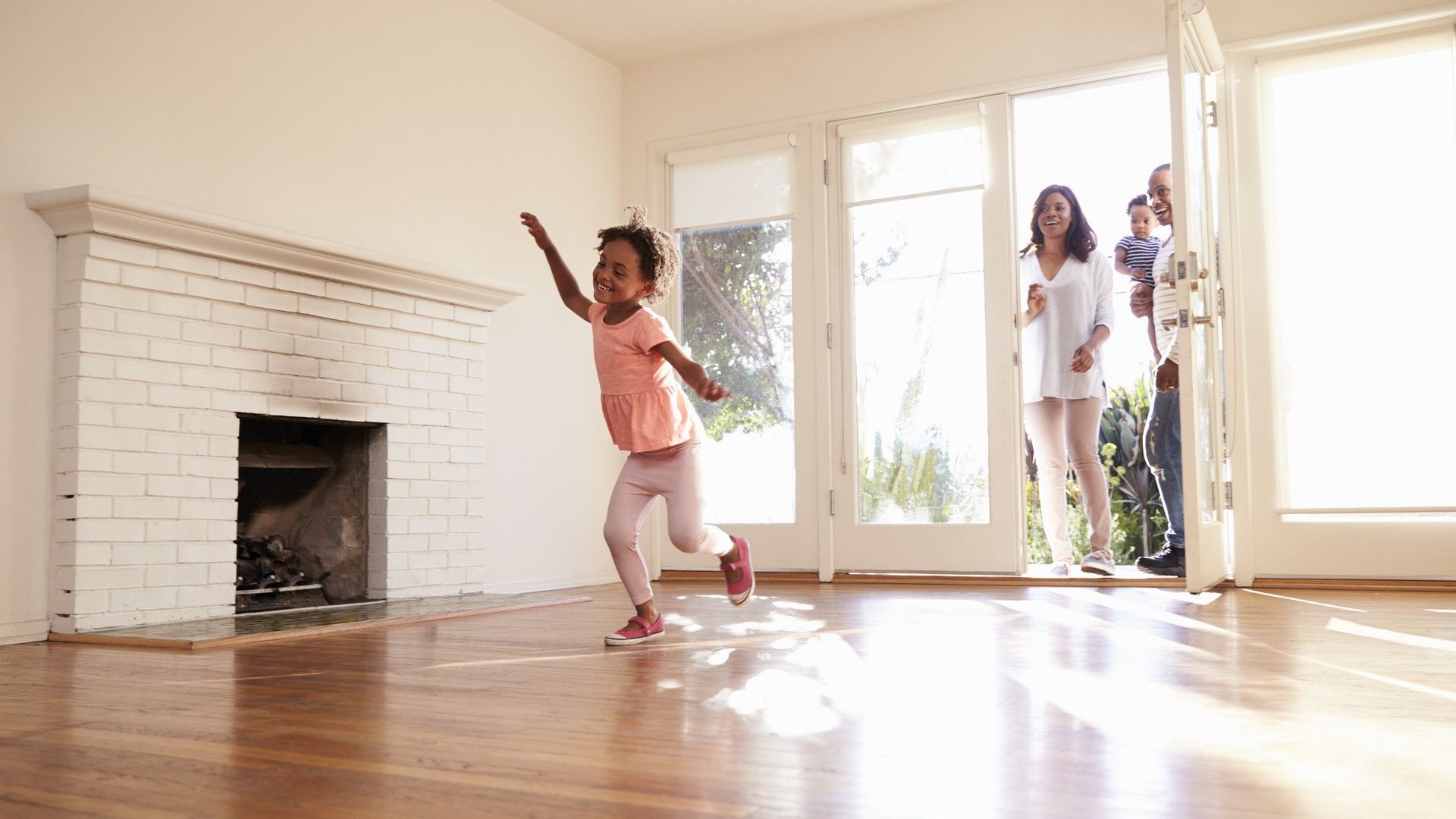 Elegant living room showcases exquisite hardwood floors and classic white brick fireplace, luxury in Cypress, TX