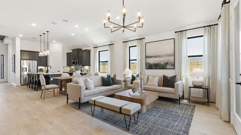 Luxurious open space with hardwood floors, sleek cabinetry, and chic chandelier in Oakwood Estates.