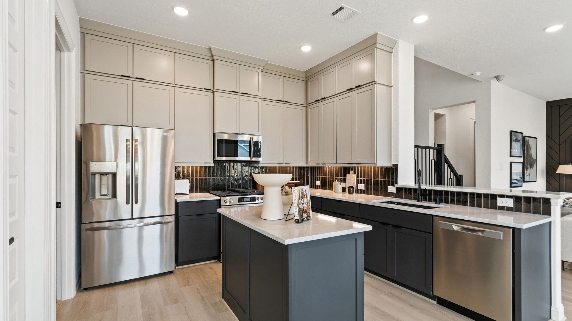 Elegant kitchen with high-end cabinetry, luxurious countertops, and premium appliances in Park at Eldridge, Houston.