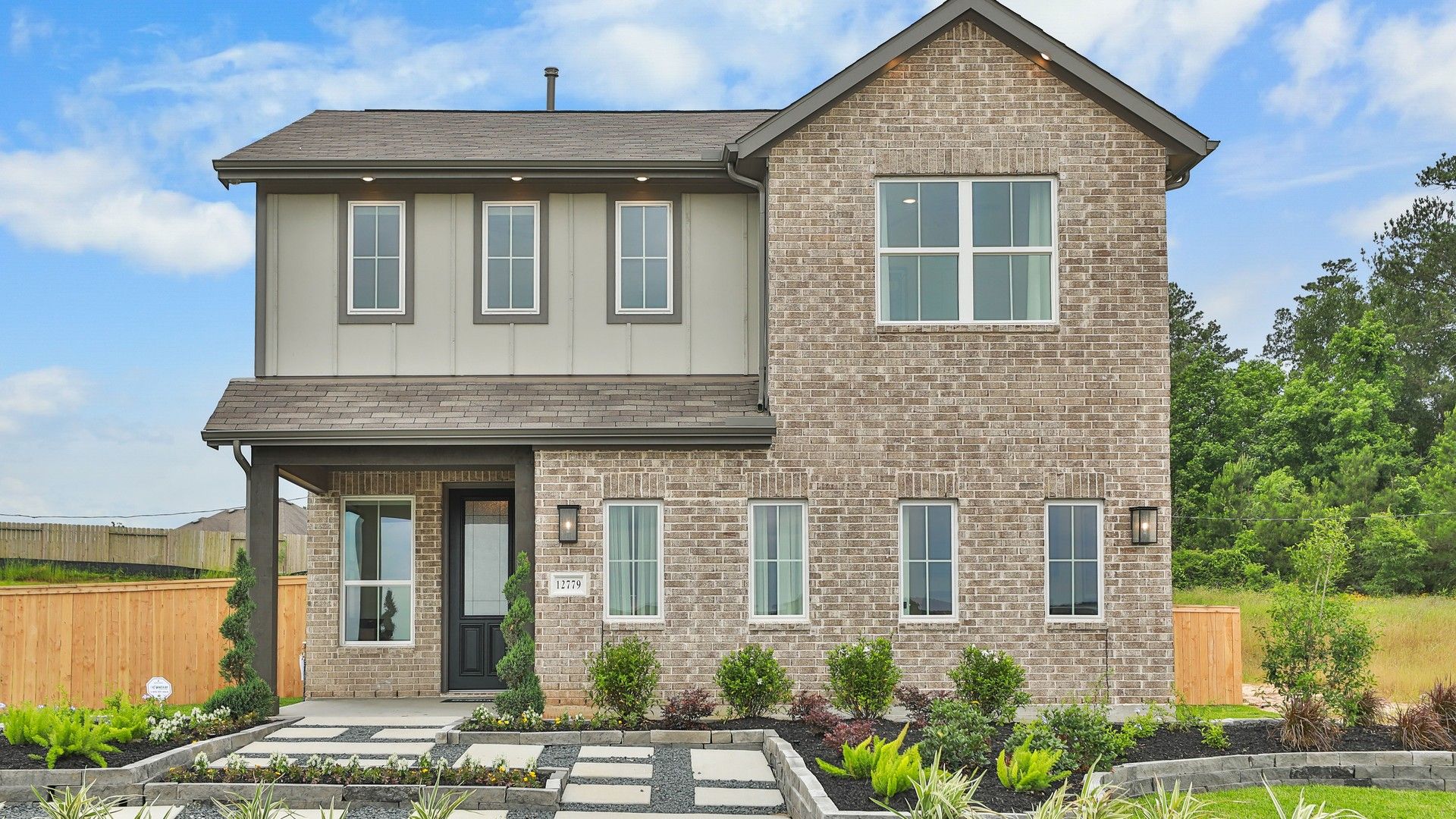 Elegant brick facade with sleek lines and expansive windows. Mostyn Springs offers landscaped serenity.