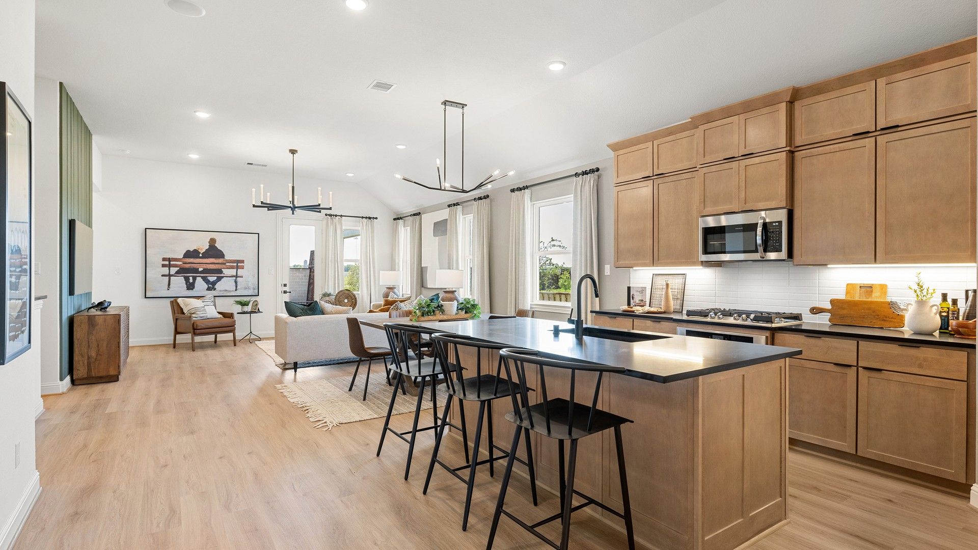 Spacious open-plan living area with elegant wooden cabinets, sleek modern fixtures in Southern Pointe, Texas. [111]