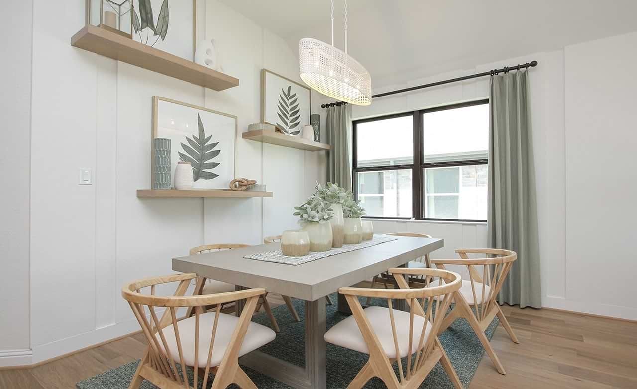 Sophisticated dining area features minimalist design, sleek wooden furniture, modern light fixture in Sunterra.
