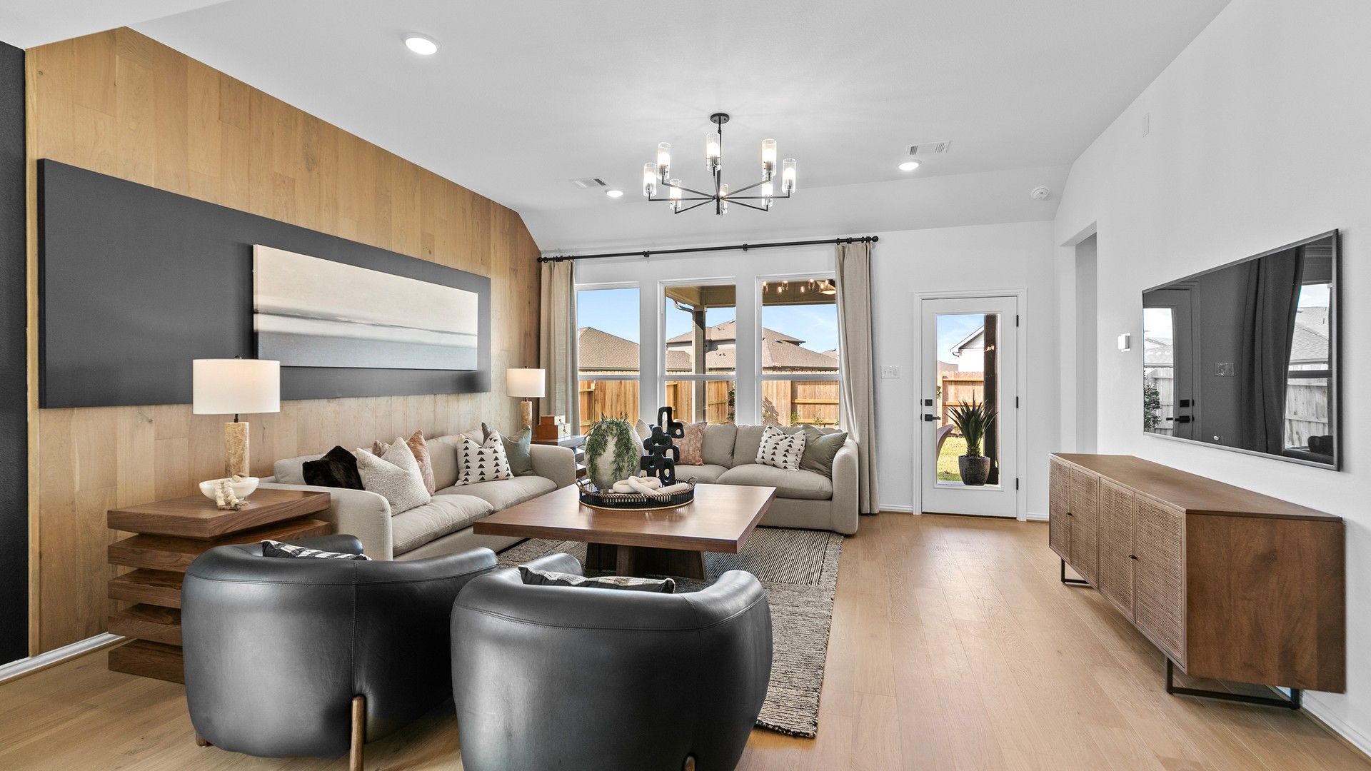 Elegant living room features wood accents and sleek lighting, offering style and comfort in River Ranch.