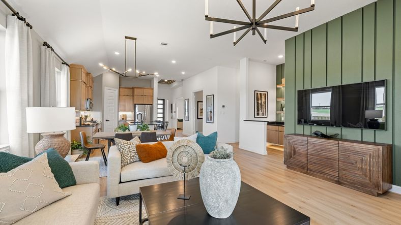 Experience elegance with sleek chandeliers, textured wood features, and a bold green accent wall in Southern Pointe.