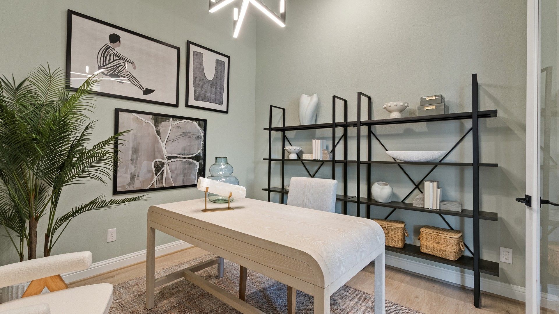 Discover elegance with a sculptural desk, geometric chandelier, and minimalistic shelving in Oakwood Estates.