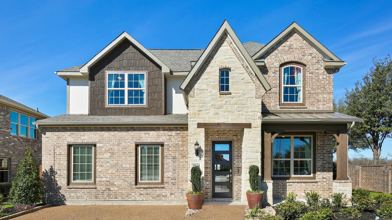 Stunning Creekhaven home with elegant brickwork, pristine stone features, and expansive windows.
