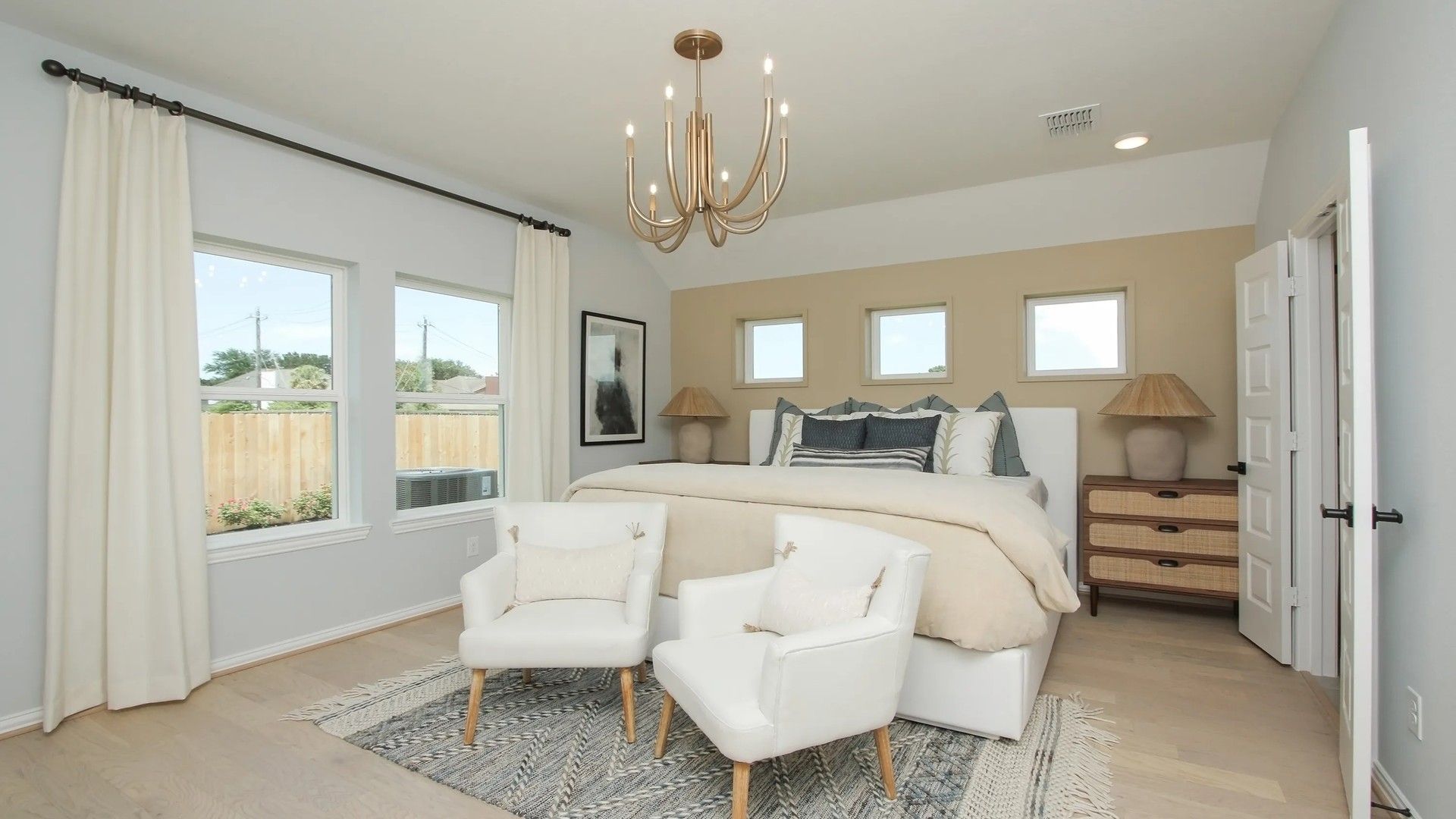 Experience refined living with sleek chandelier, soft beige palette, and expansive windows in Ellis Cove.