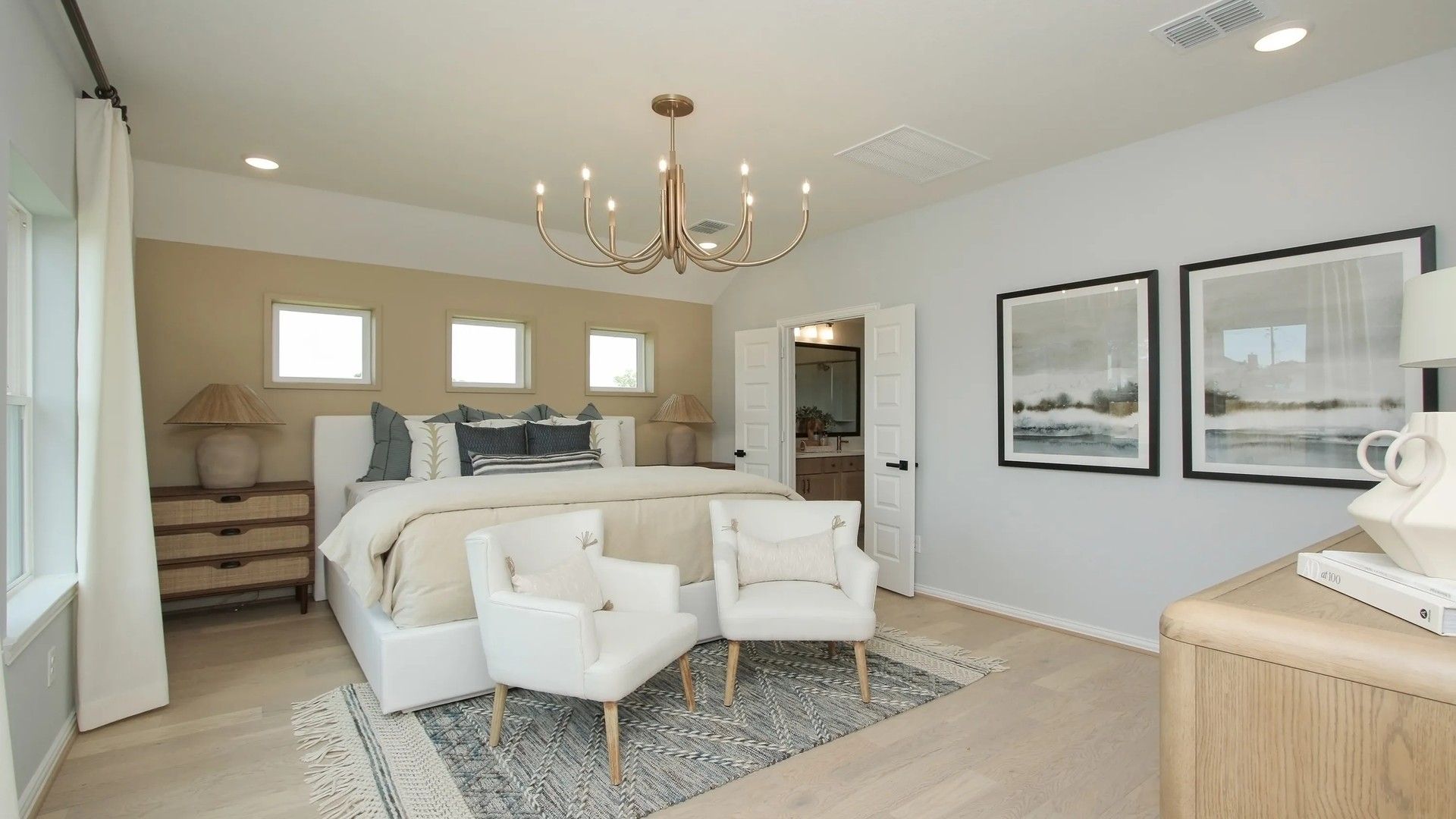 Sophisticated bedroom showcases elegant chandelier and serene decor in Ellis Cove community.