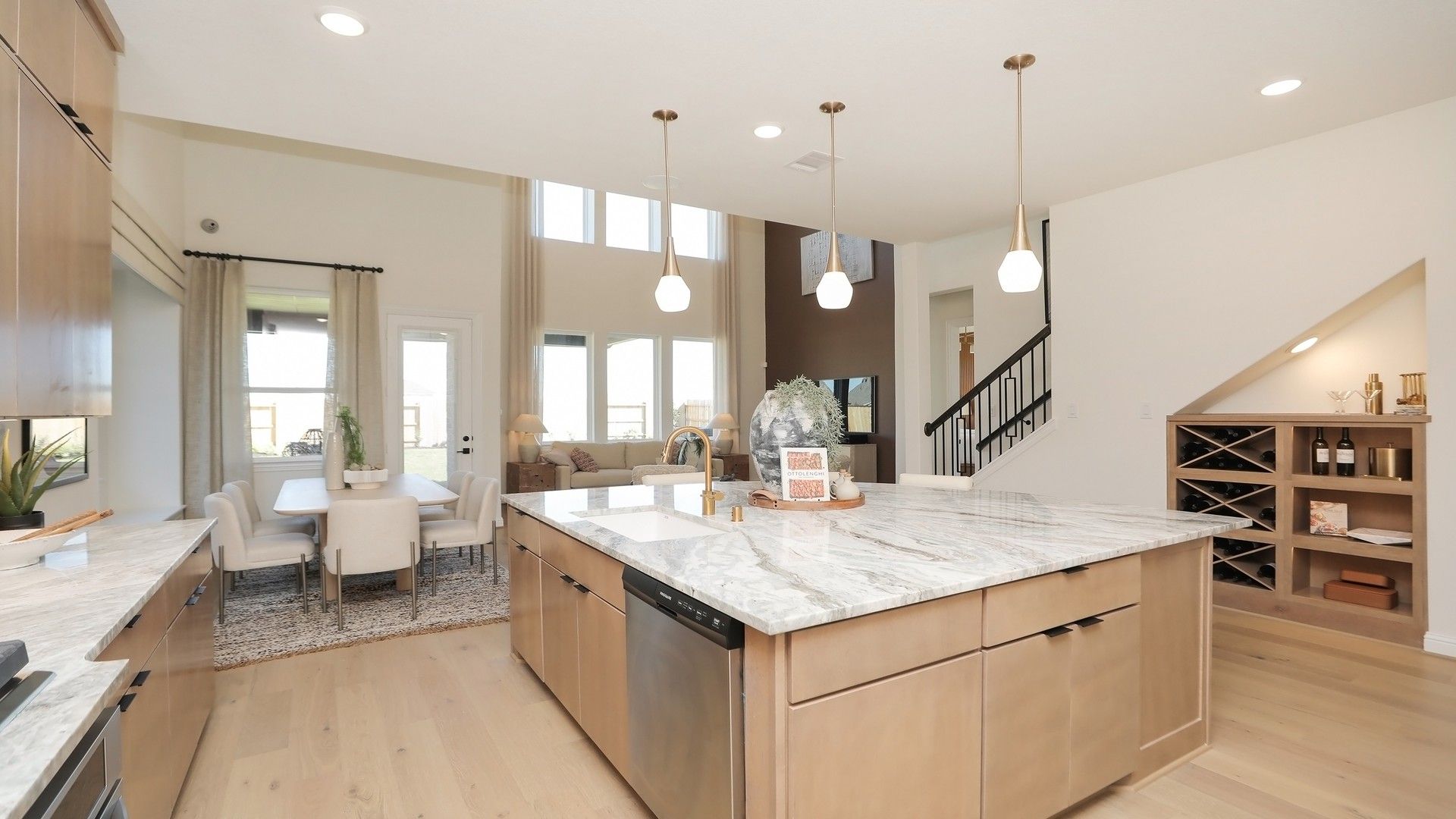 Elegant marble countertops and pendant lights highlight this exquisite kitchen in Brookewater community.