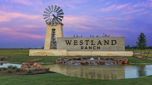 Dramatic stone entrance with striking windmill and serene pond. Westland Ranch, Texas.