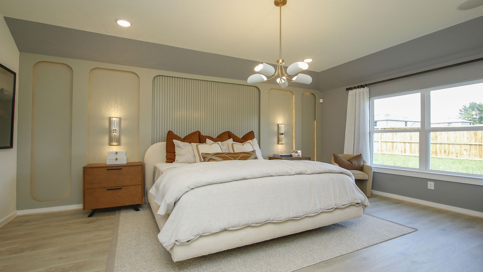 Stunning wall paneling and oversized windows enhance this luxury bedroom’s sophisticated ambiance in Cielo.