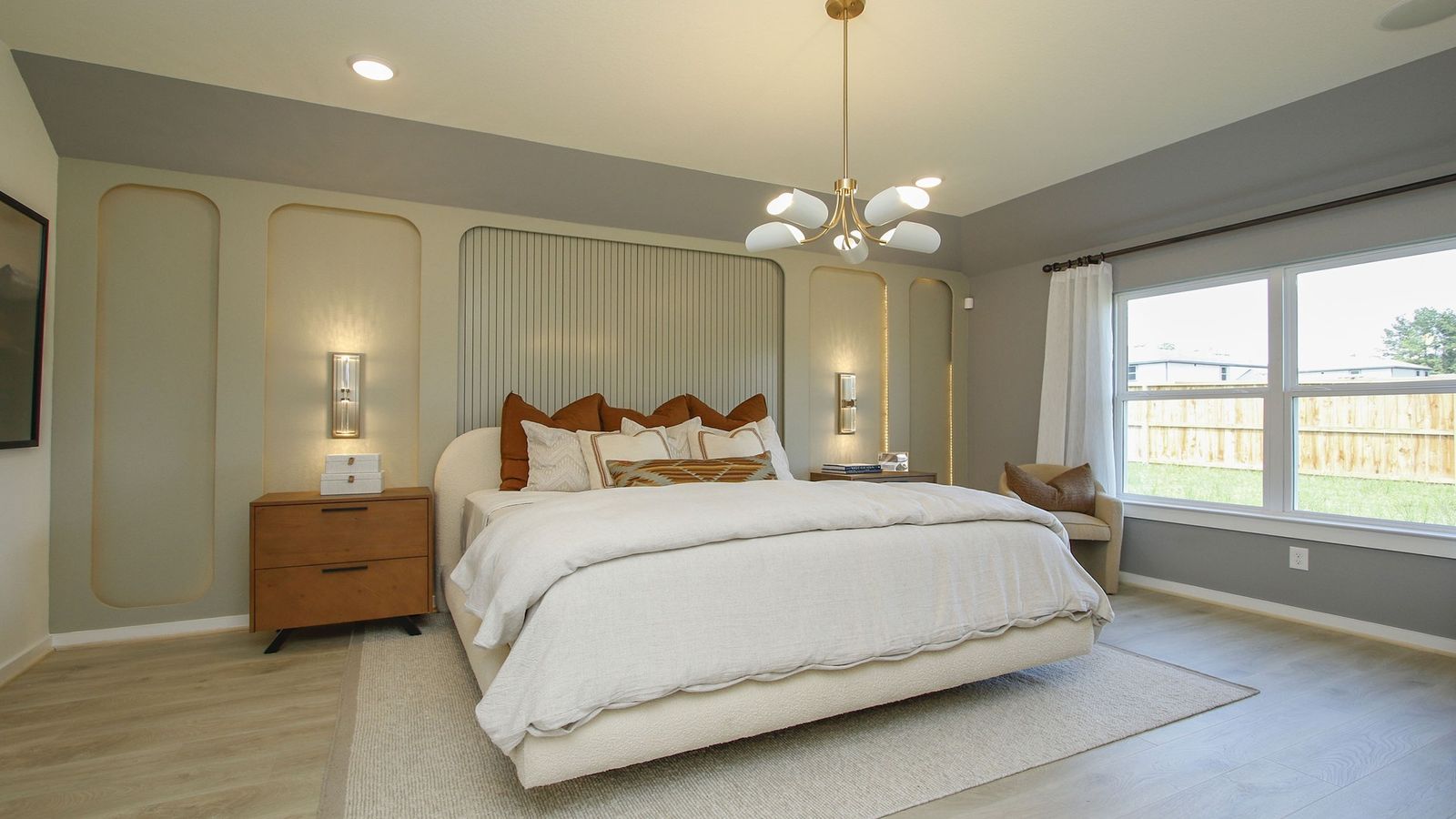 Stunning wall paneling and oversized windows enhance this luxury bedroom’s sophisticated ambiance in Cielo.