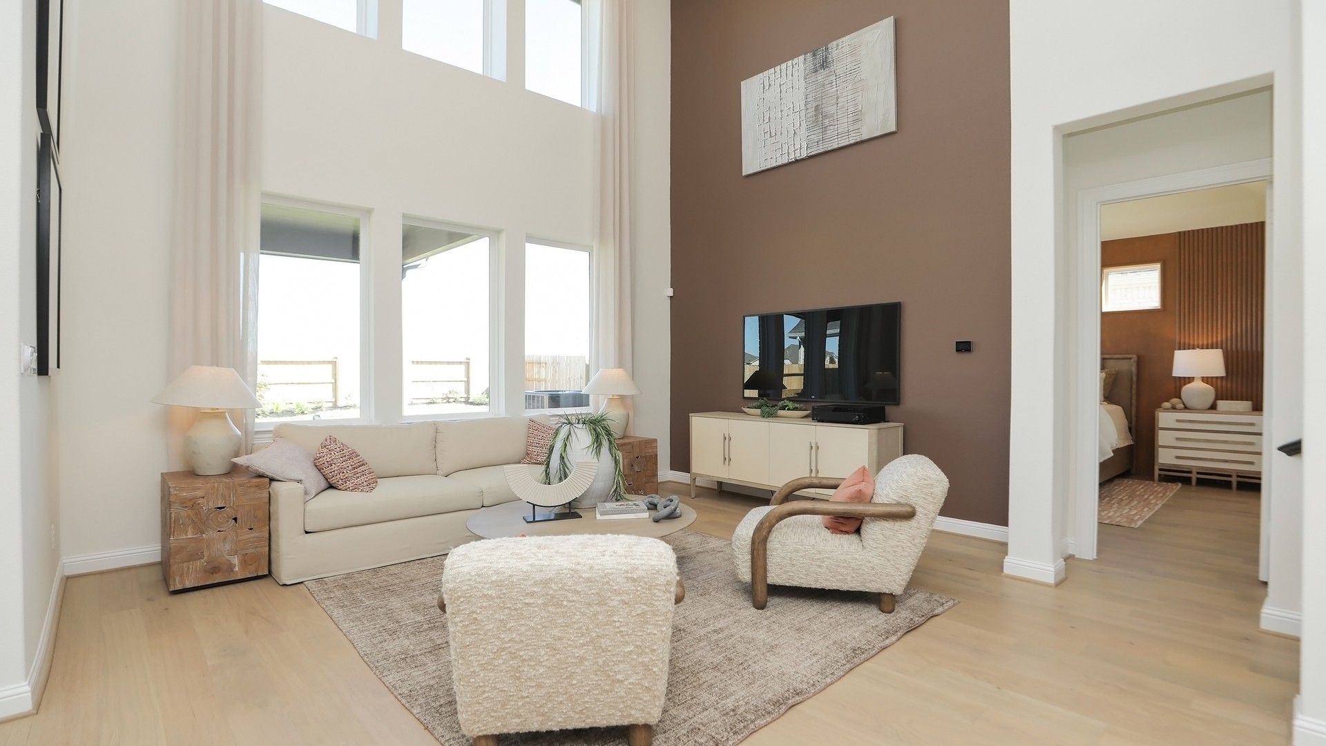 Luxurious high ceilings, expansive windows, and stylish accents define this Brookewater living space.