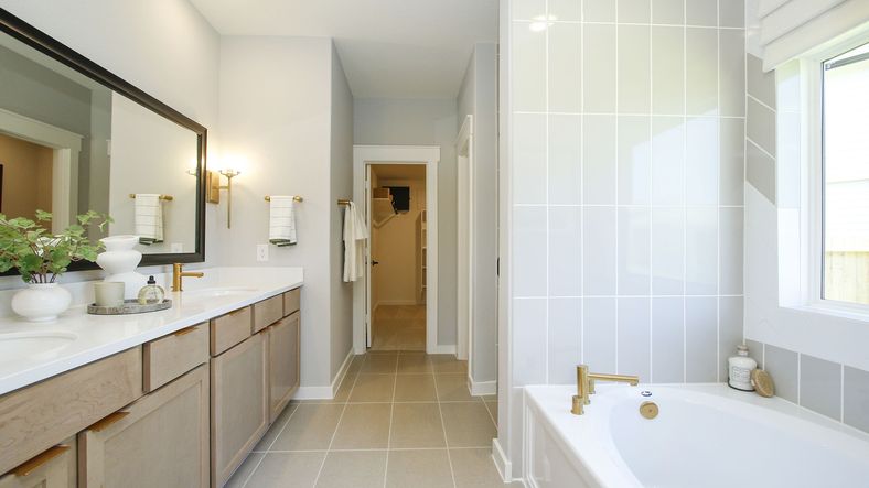 Elegant bathroom in Cielo featuring marble counters, dual sinks, and luxe gold fixtures. Exquisite design.