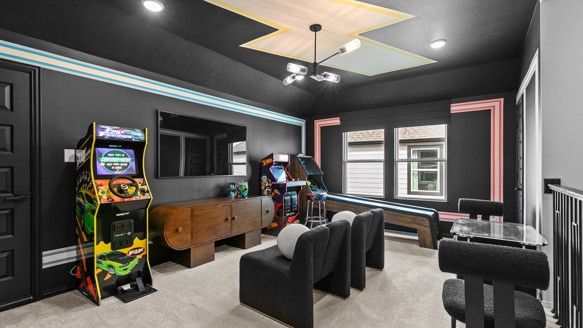 Experience luxury in River Ranch with plush seating, arcade classics, and a striking geometric ceiling design.