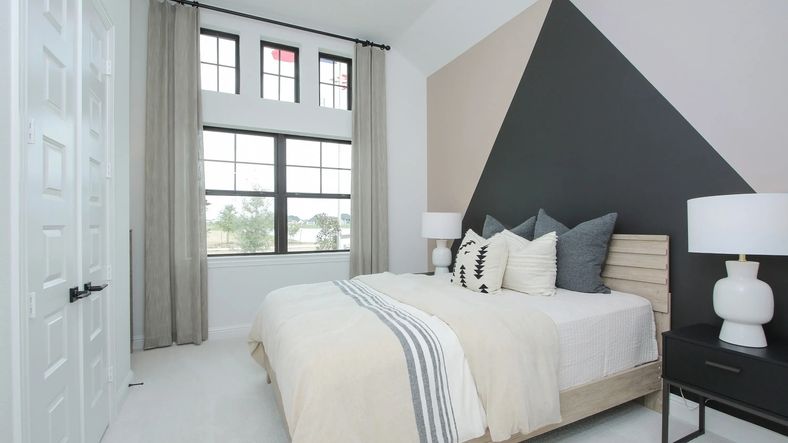 Geometric accent wall in this Coastal Point bedroom showcases modern design and sleek aesthetics.