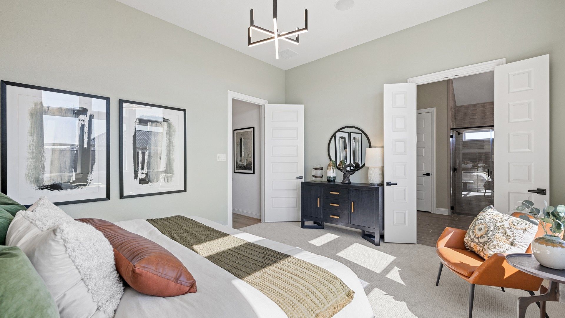 Southern Pointe bedroom boasts refined French doors and a statement chandelier, exuding ultimate sophistication.