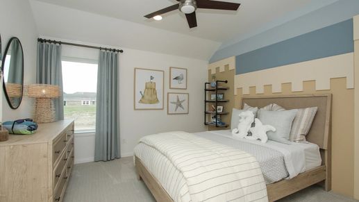 Elegant bedroom in Ellis Cove, featuring a unique castle-themed accent wall and sleek modern fan for luxury ambiance.