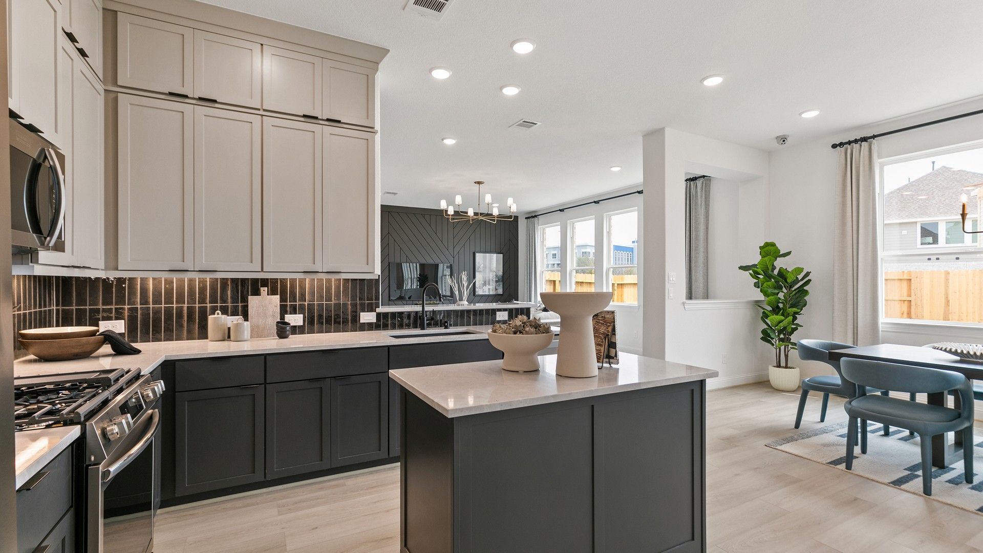 Sleek quartz countertops and refined cabinetry define this luxurious kitchen in Park at Eldridge.