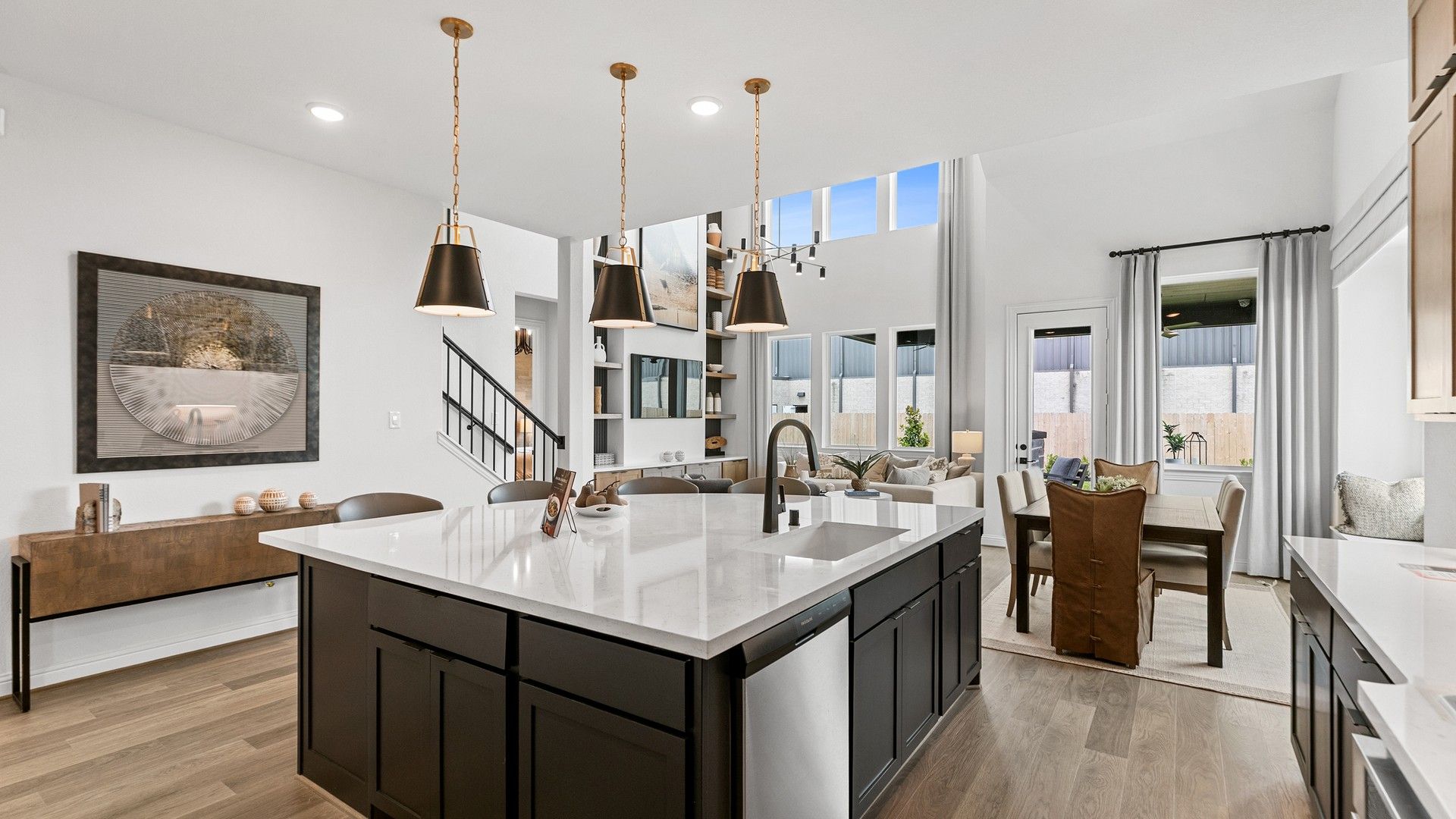 Sophisticated kitchen with marble island and pendant lights. Vaulted ceilings enhance Beamer Villas luxury.
