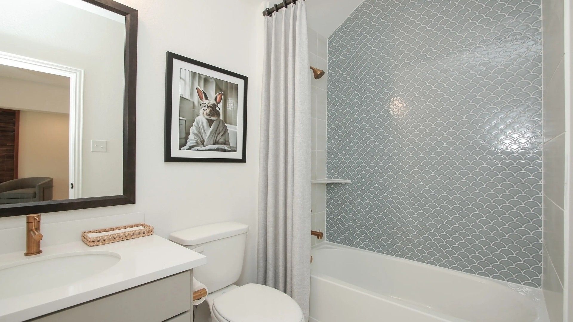 Discover elegance with scallop tile and custom vanity in Ellis Cove's exquisite bathroom setting.