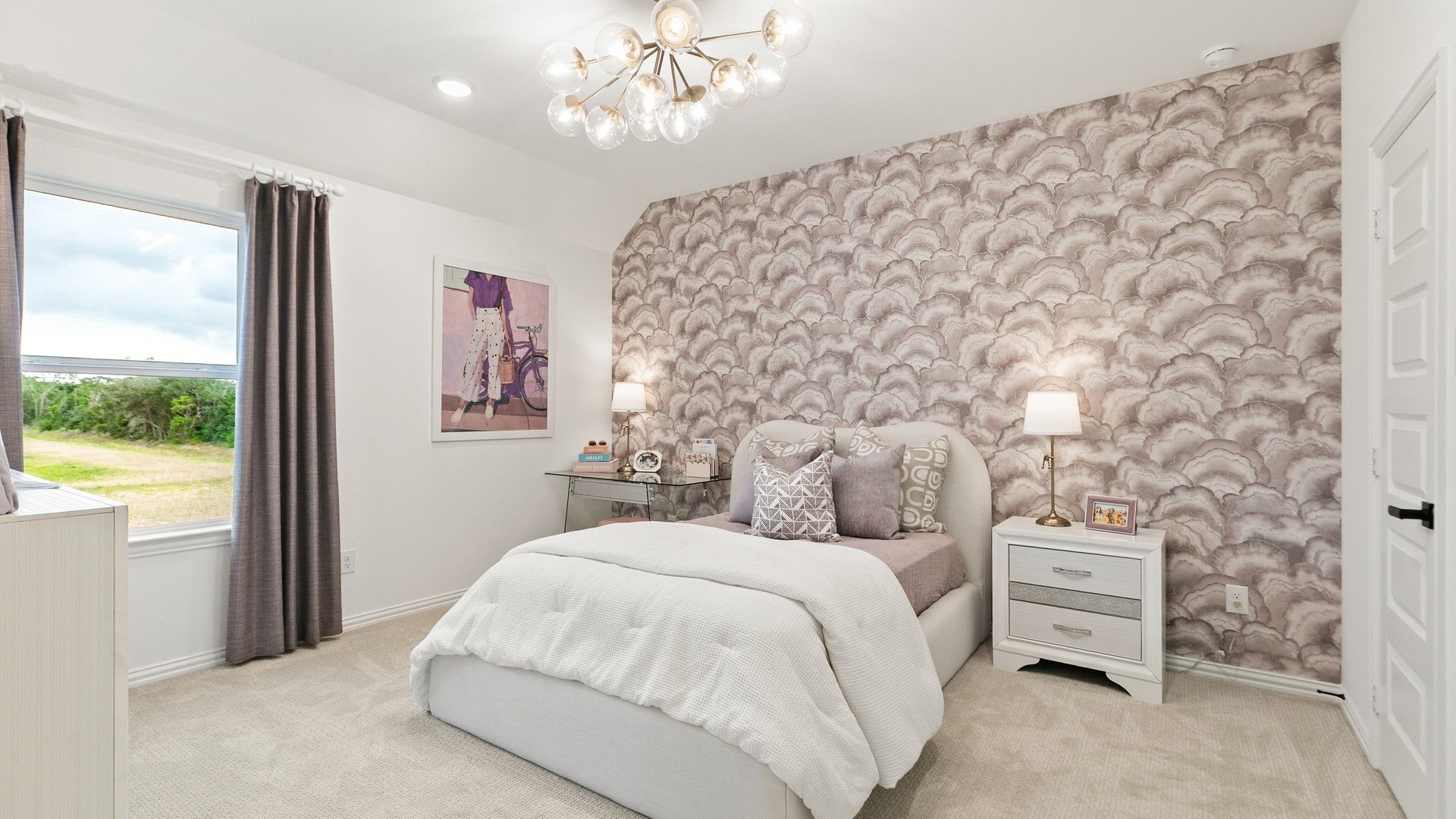 Experience sophistication with a cloud-themed accent wall, plush carpeting, and a designer light fixture in Katy Lakes.