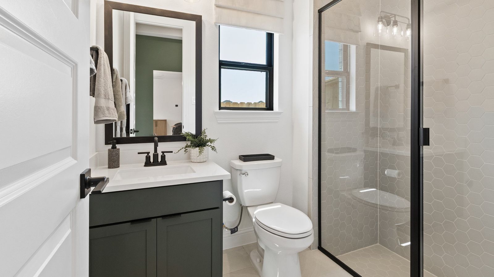 Luxurious hexagonal tiling and sleek fixtures enhance this Oakwood Estates bathroom's refined elegance.