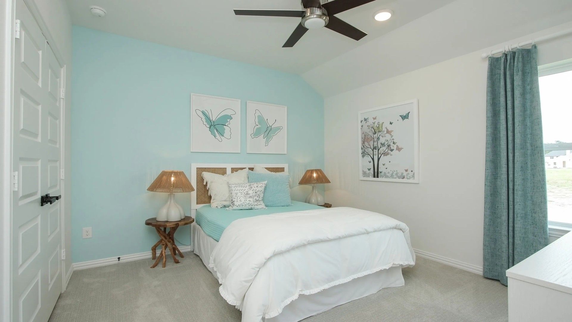 Featuring elegant butterfly art, soft hues, and refined decor, this Ellis Cove bedroom exudes sophistication.