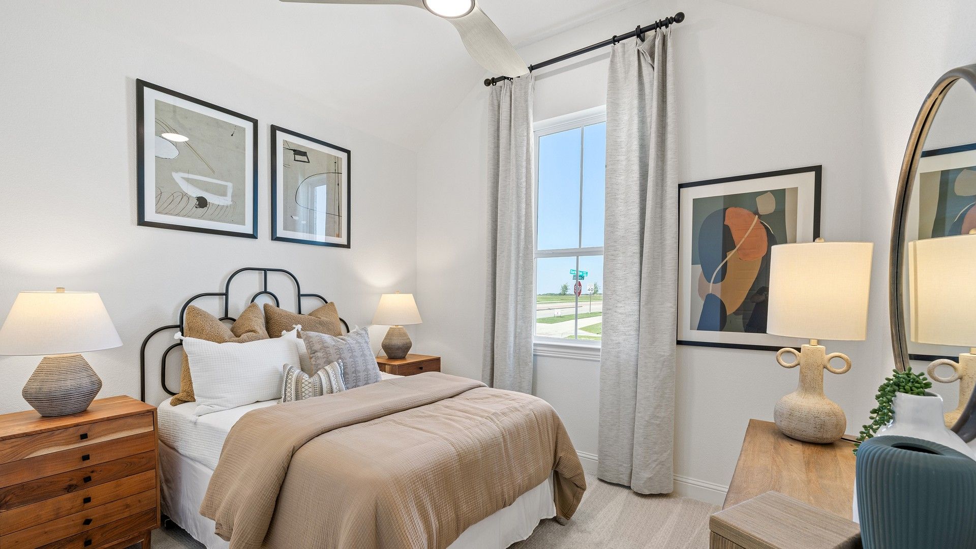 Experience luxury with rich wood accents, modern art, and a sunlit ambiance in Southern Pointe's bedroom.