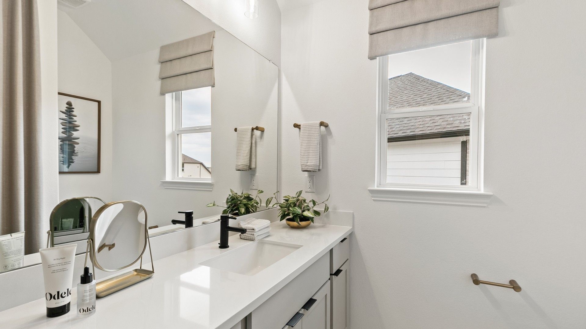 Indulge in luxury with dual-sink vanities and sleek finishes in Katy Lakes' elegant bathroom.