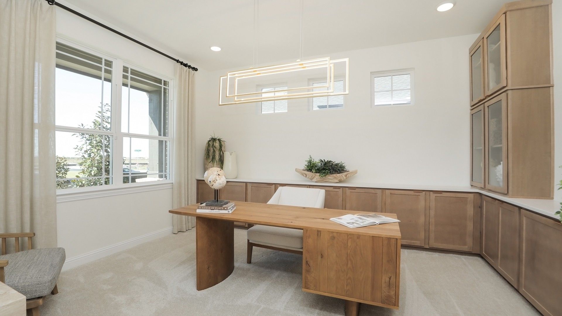Luxurious home office with custom wood cabinetry and sleek lighting in Brookewater.