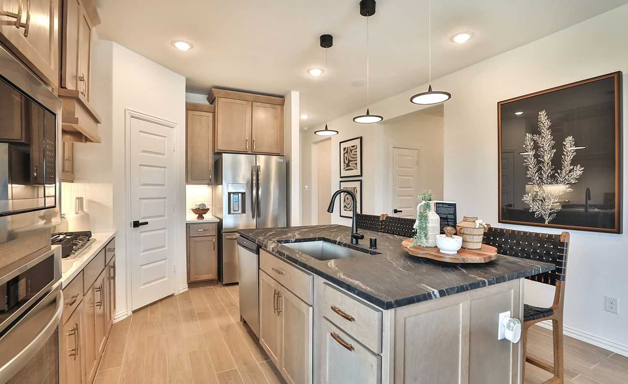 Luxurious marble island, elegant wood cabinetry, and premium stainless appliances in Bridgeland's upscale kitchen.
