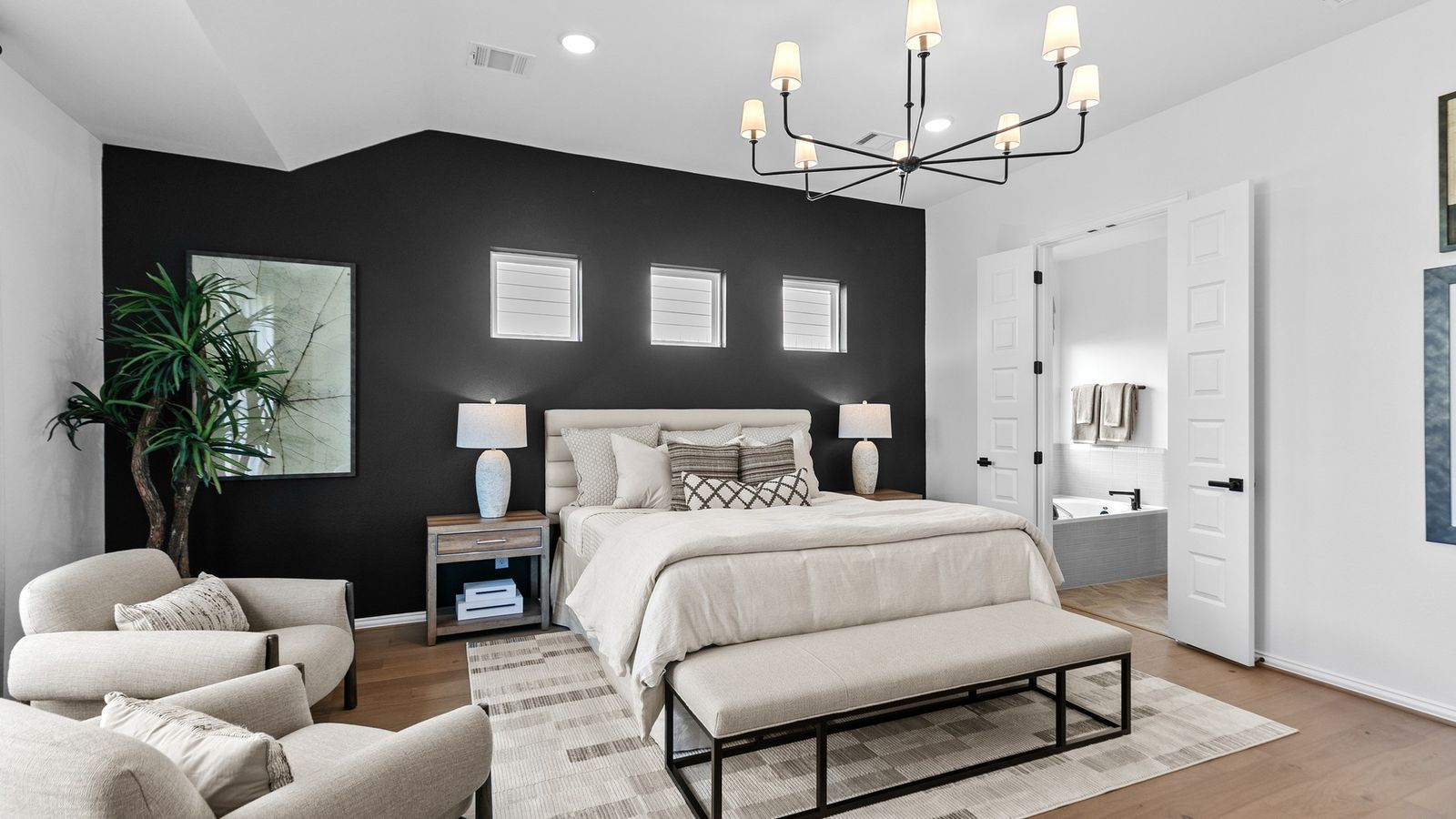 Experience luxury with a sleek black accent wall and sophisticated chandelier in River Ranch.