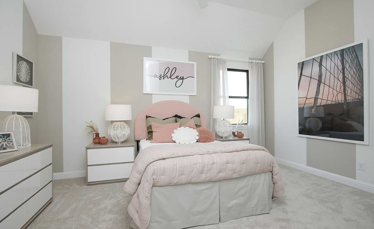 Luxurious Sunterra bedroom features plush bedding, modern accents, and ample natural light for serene living.