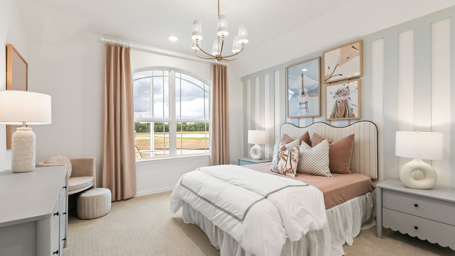 Luxurious bedroom featuring a classic arched window, bespoke striped wall, and chic chandelier in Katy Lakes.